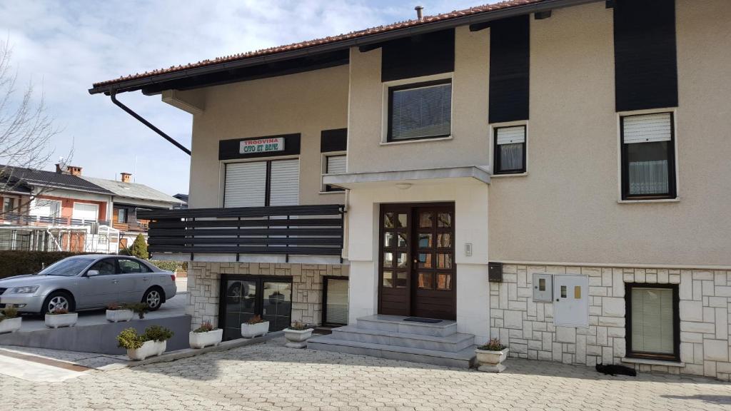 a house with a car parked in front of it at Apartma Rodica in Domžale