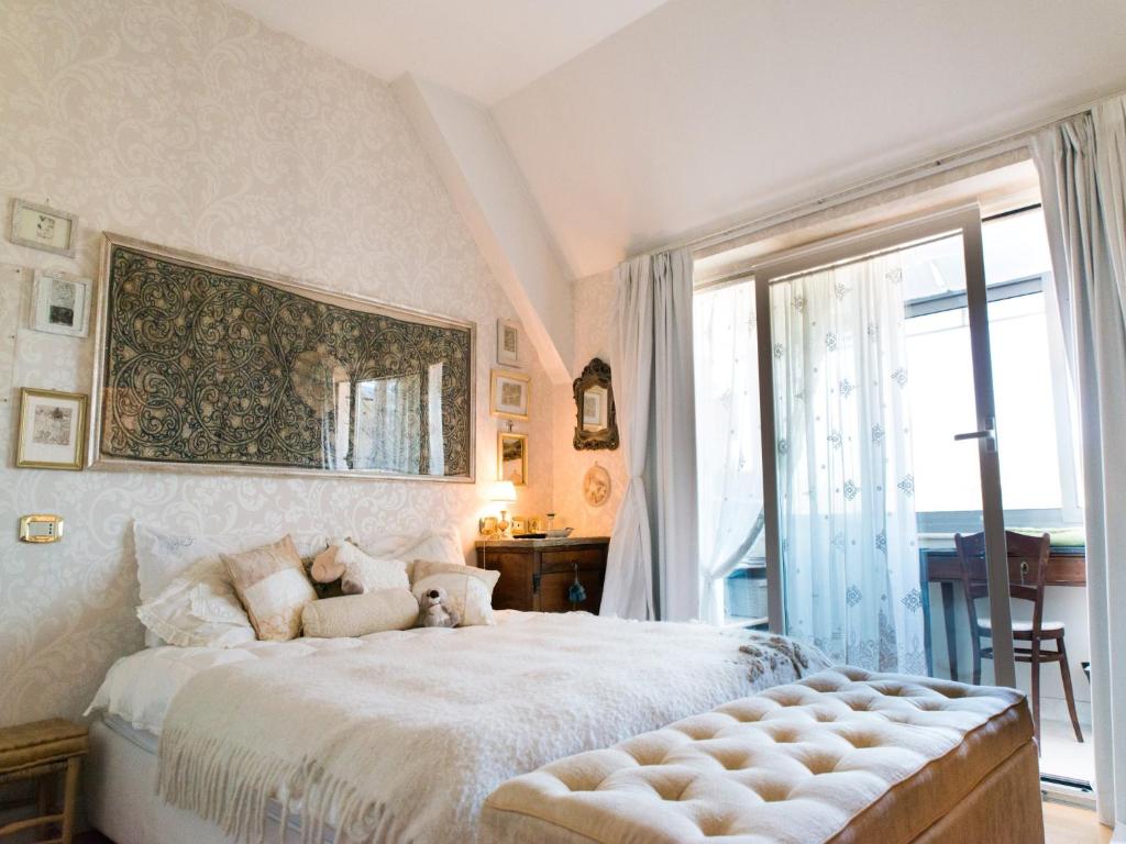 a bedroom with a large bed with a large window at Casa Malena in Ascoli Piceno