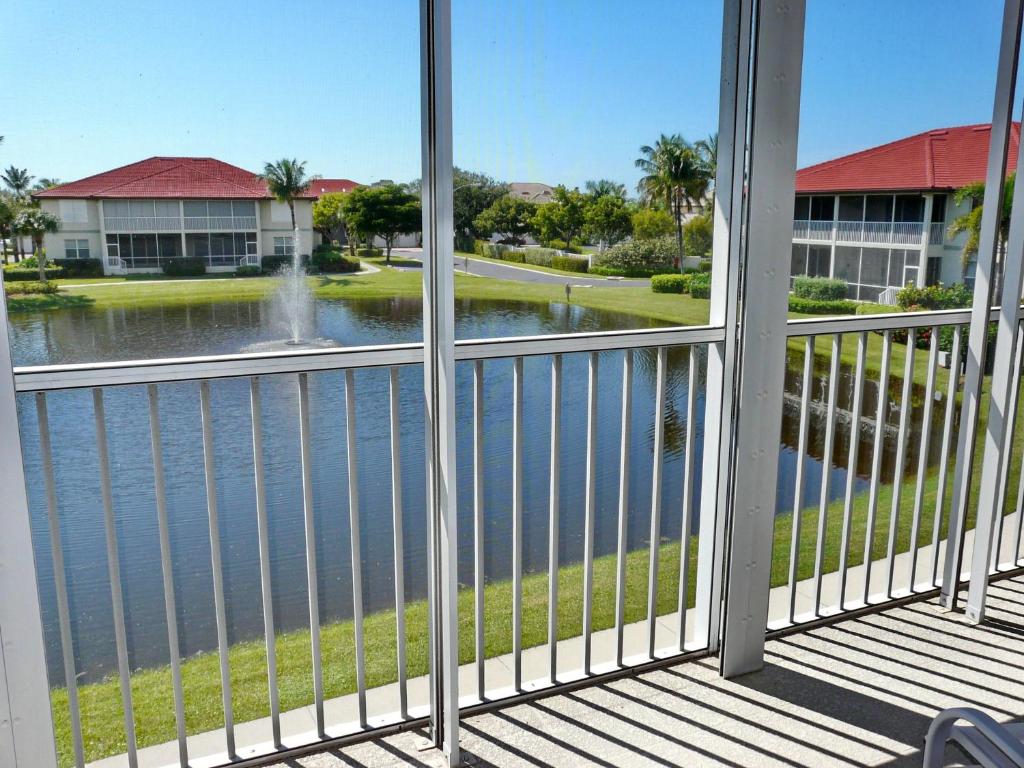 a balcony with a view of a body of water at Quiet, gated community with pool and tennis courts in Marco Island