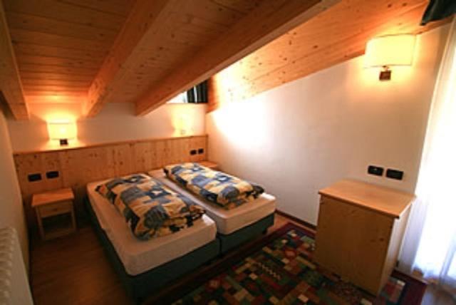 Postel nebo postele na pokoji v ubytování Residence Dolomia