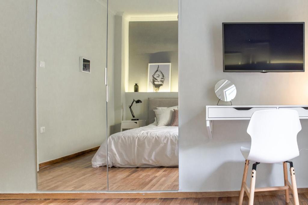 Televízia a/alebo spoločenská miestnosť v ubytovaní Muses Residence