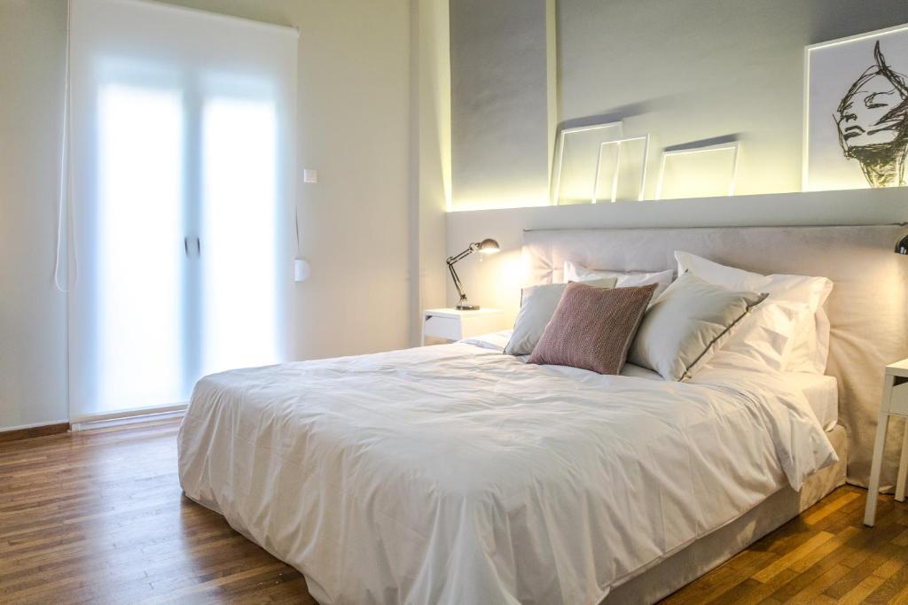 Posteľ alebo postele v izbe v ubytovaní Muses Residence