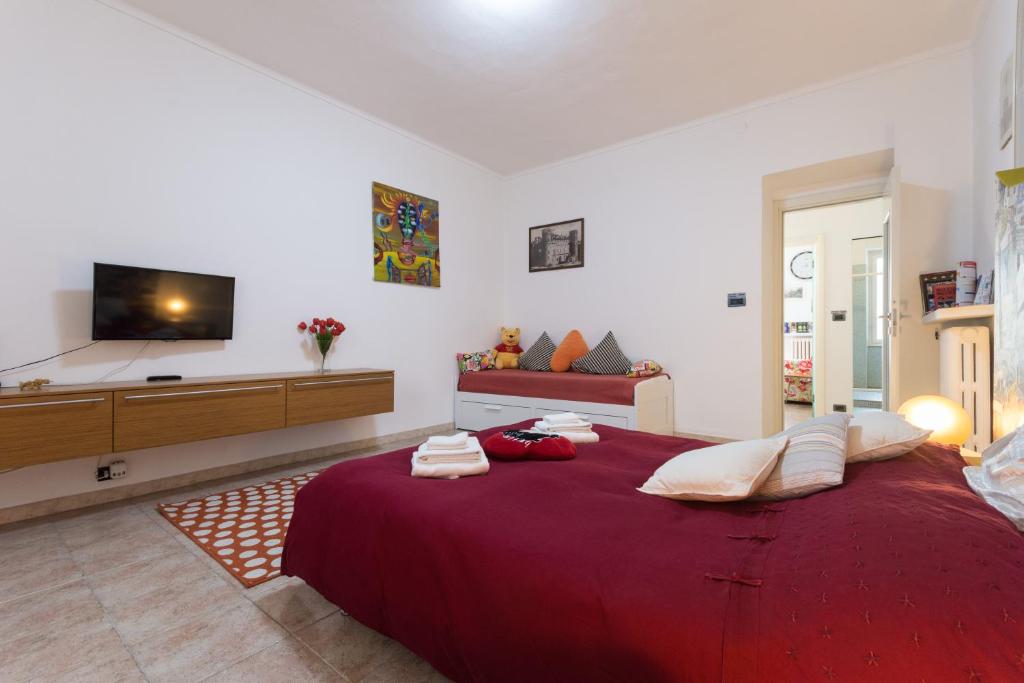 a large red bed in a room with a tv at Apartment Silvia in Turin