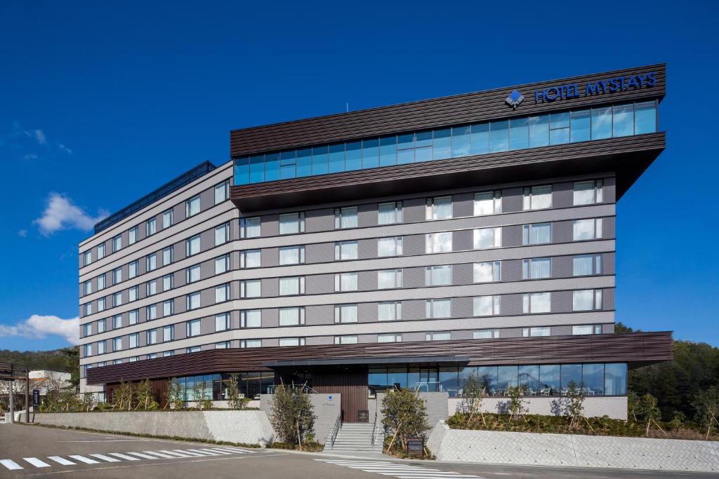 a building with a hotel atlas sign on it at HOTEL MYSTAYS Fuji Onsen Resort in Fujiyoshida