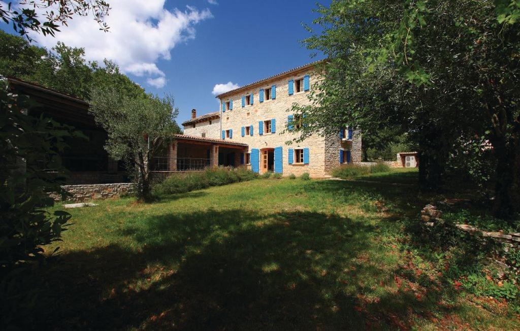 a large brick building with a grass yard in front of it at Villa Dusan 1212 in Svetvinčenat