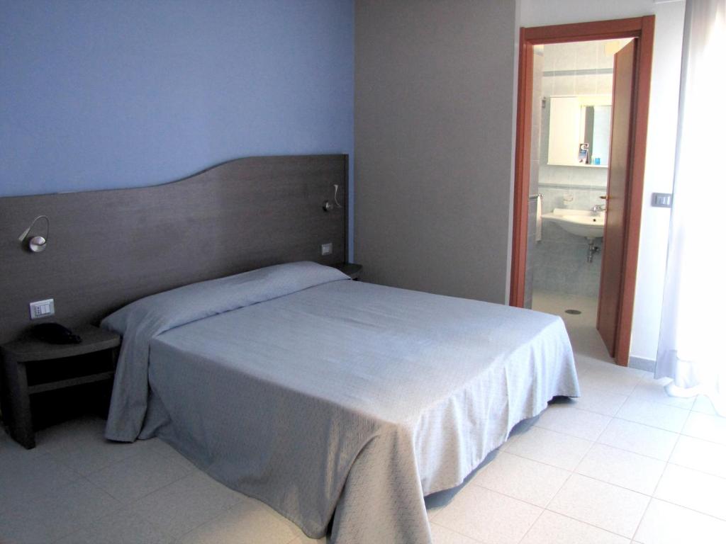 Postel nebo postele na pokoji v ubytování Hotel Acquario