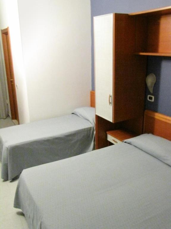 Postel nebo postele na pokoji v ubytování Hotel Acquario