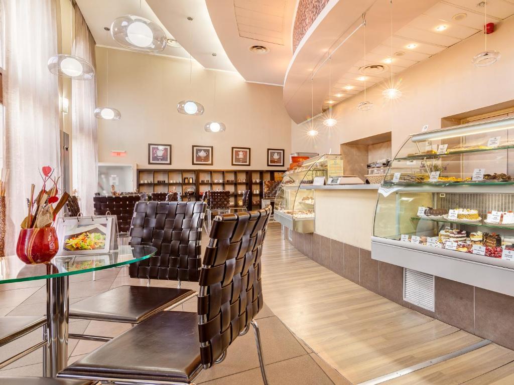 a restaurant with a table and chairs and a counter at Continental Forum Sibiu in Sibiu
