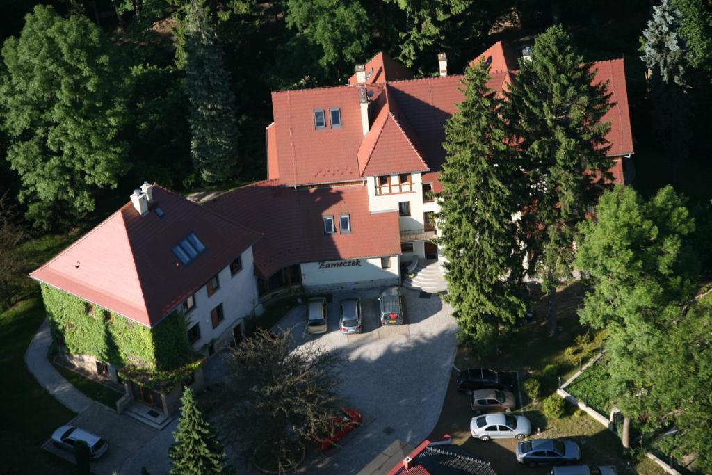 an aerial view of a large house with trees at Willa Zameczek in Polanica-Zdrój