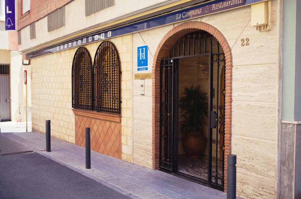 an entrance to a building with a large door at Hostal la Campana in Motril