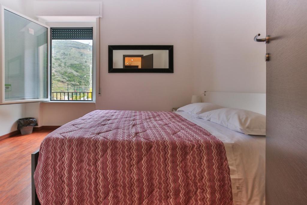 A bed or beds in a room at Sollevante Guest House