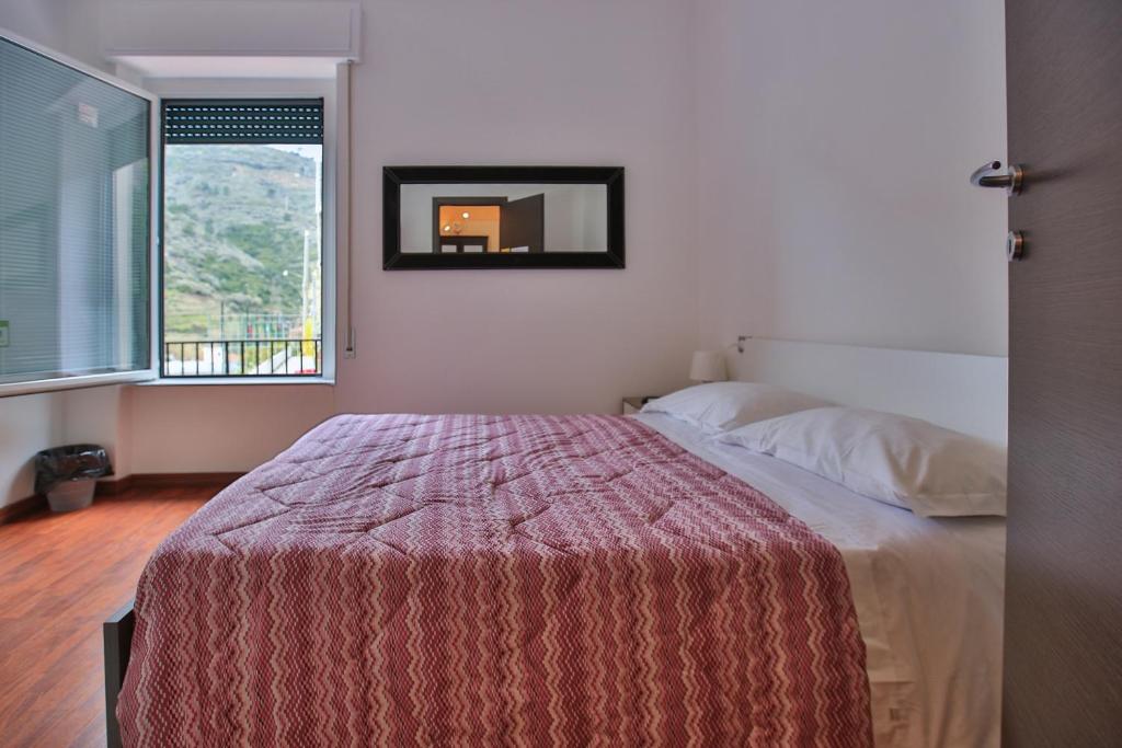 A bed or beds in a room at Sollevante Guest House
