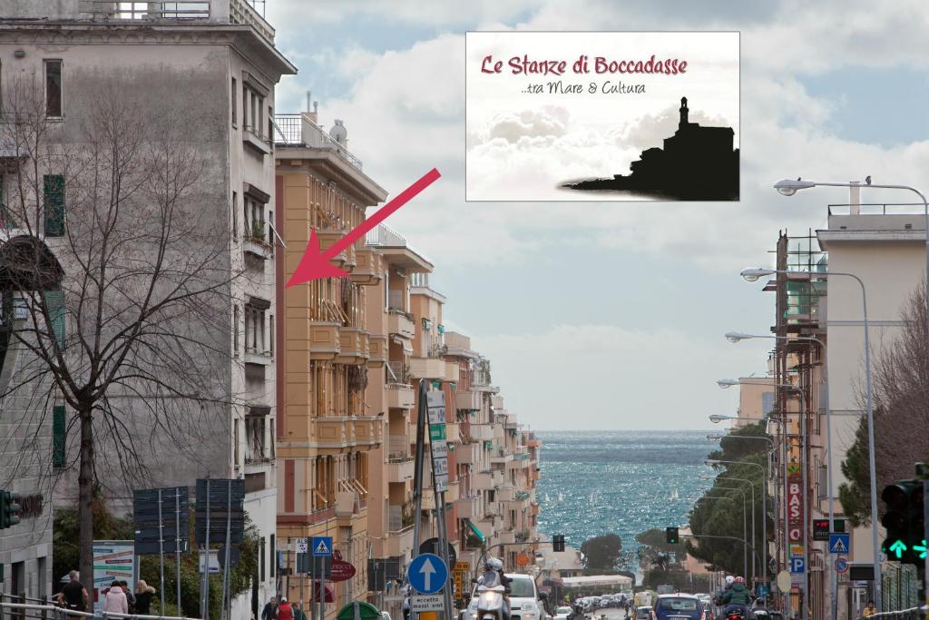 a city street with tall buildings and a sign that reads shaper of apocalypse at Le Stanze di Boccadasse in Genova
