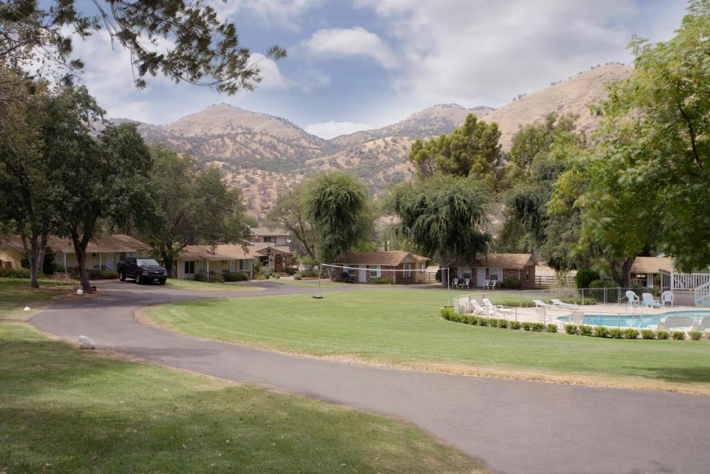 a winding road in a park with mountains in the background at Lazy J Ranch Motel in Three Rivers