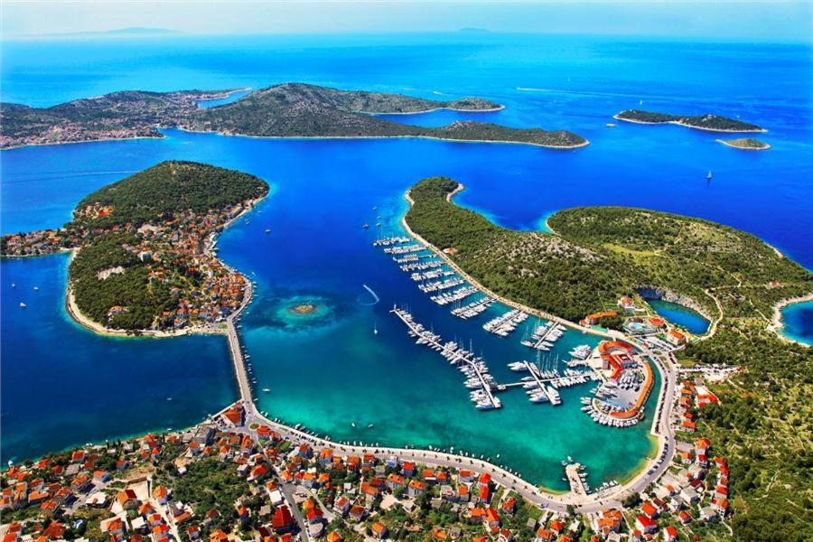 an aerial view of an island with boats in the water at Villa Tina in Rogoznica