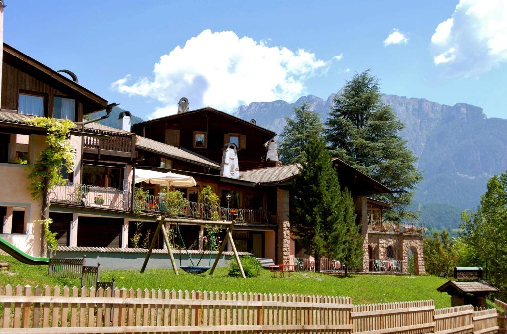 a house with a playground in front of it at Park Hotel Villa Trunka Lunka in Cavalese