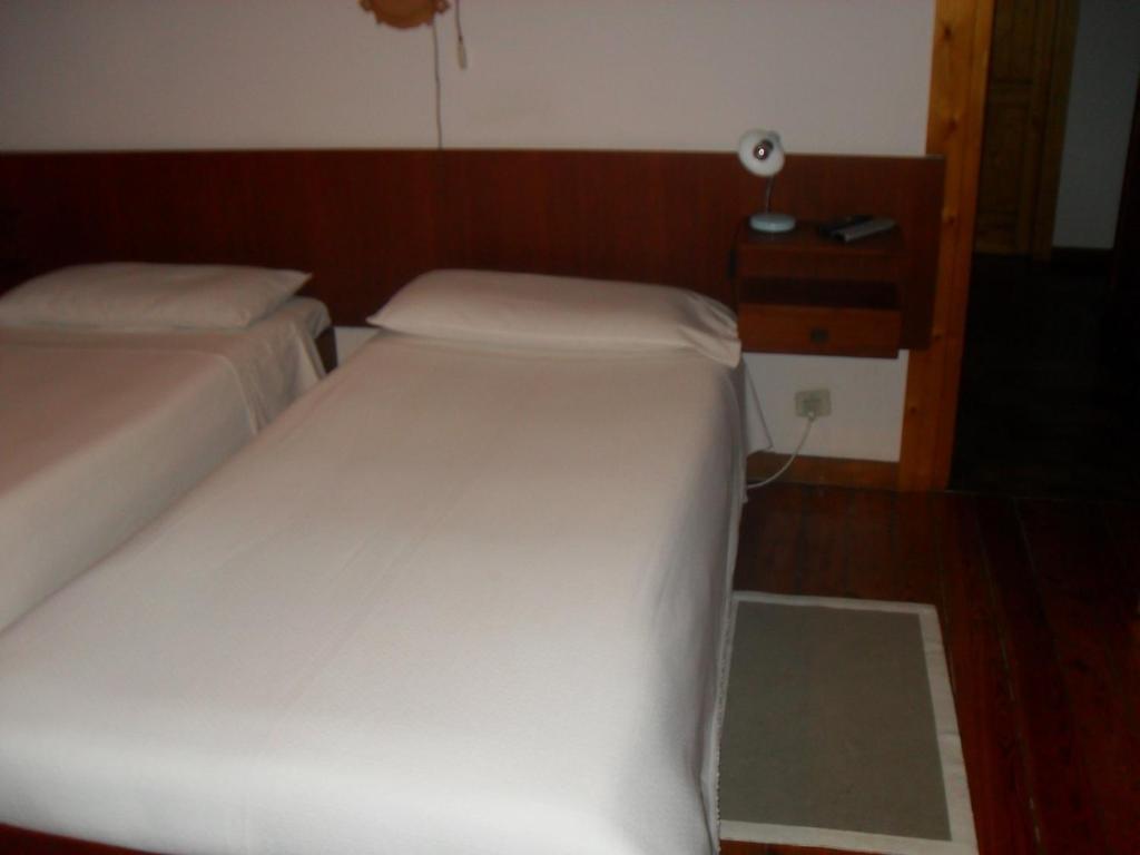 Postel nebo postele na pokoji v ubytování Albergo La Genzianella