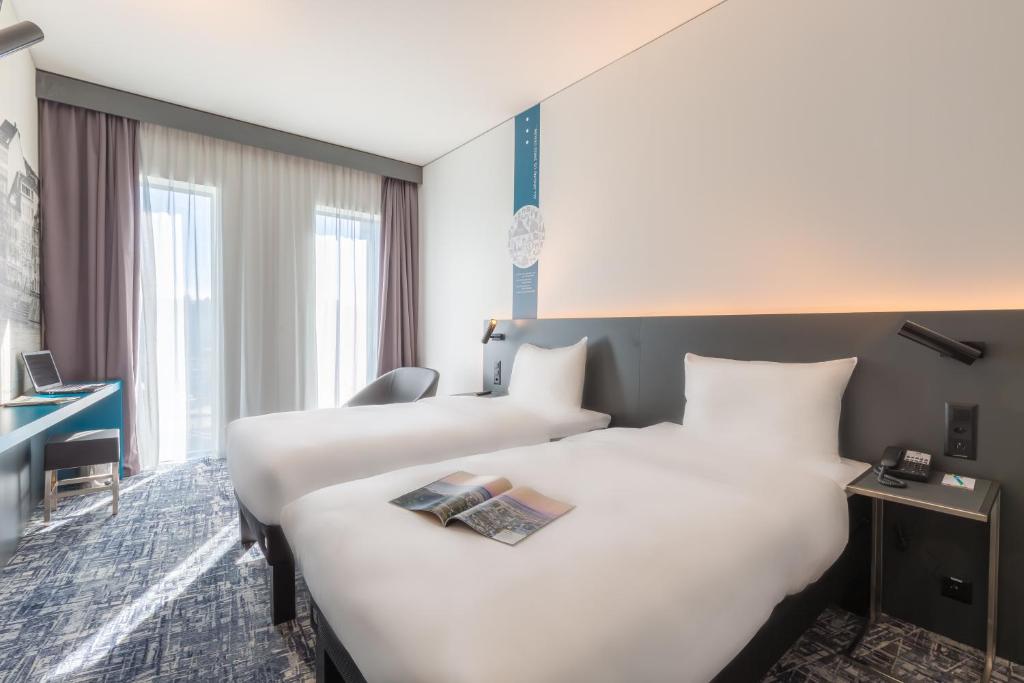 Postel nebo postele na pokoji v ubytování ibis Styles Basel City