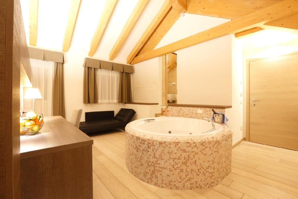 a bathroom with a large tub in the middle of a room at Grand Hotel Miramonti in Passo del Tonale