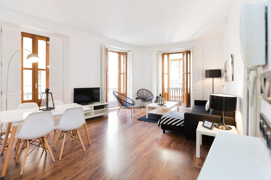 a living room with white walls and wooden floors at Total Valencia Cathedral in Valencia