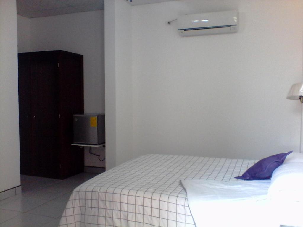 Postel nebo postele na pokoji v ubytování Hotel Las Palmas