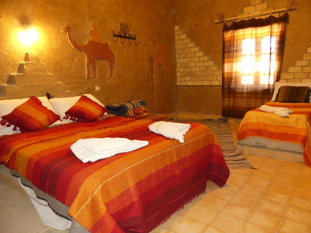 Postel nebo postele na pokoji v ubytování Hôtel Camping La Liberté