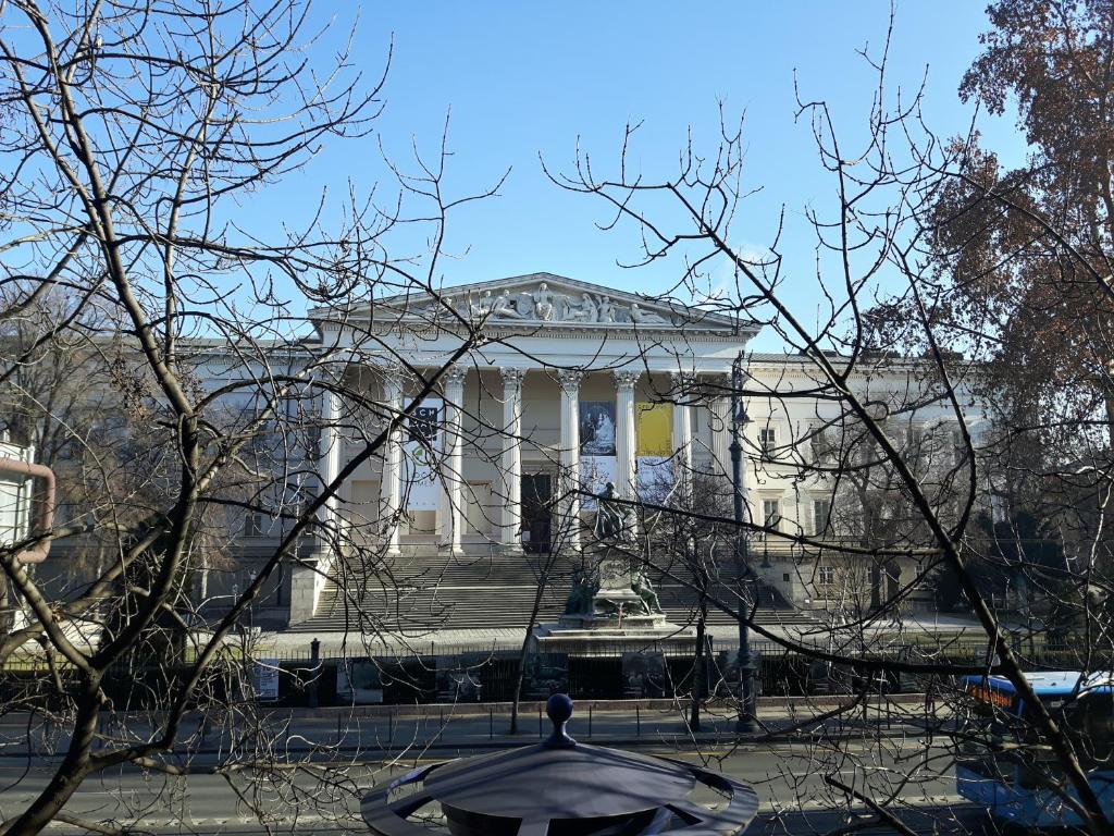 a white building with a fountain in front of it at Brand new apartment in the center in Budapest