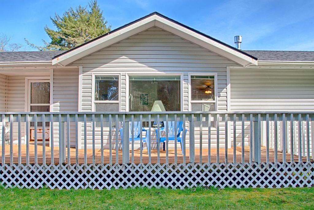 a white fence in front of a house at Allee Beach House in Westport