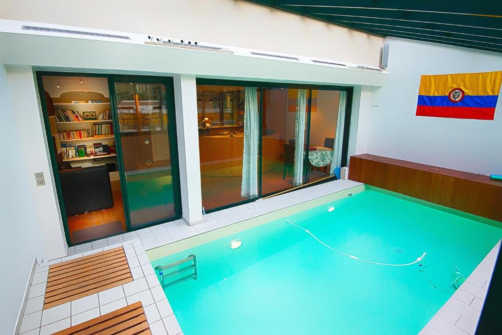 a house with a swimming pool in a room at Paris-Oasis "All Inclusive" in Paris