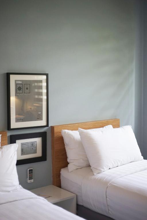 Postel nebo postele na pokoji v ubytování Allstay Ecotel Yogyakarta