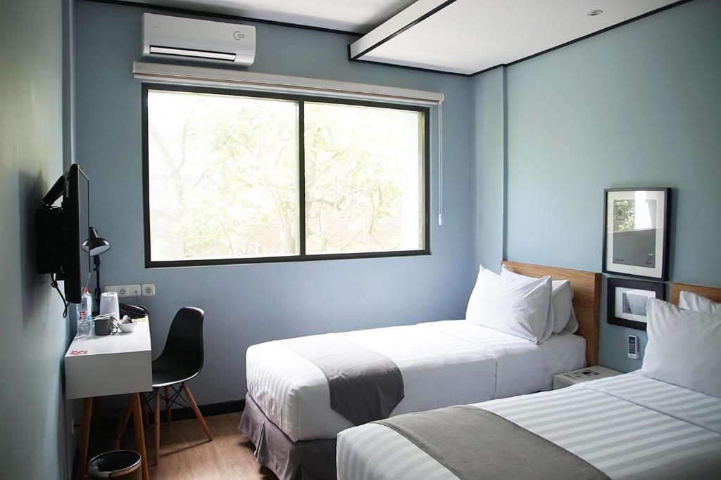 Postel nebo postele na pokoji v ubytování Allstay Ecotel Yogyakarta