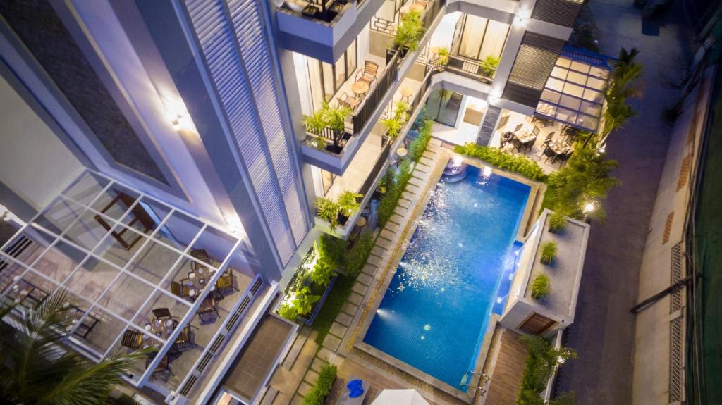 an overhead view of a swimming pool in a building at The Tito Suite Residence in Siem Reap