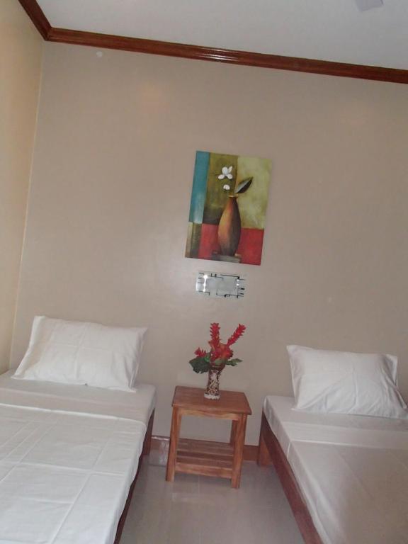 Postel nebo postele na pokoji v ubytování Malapascua Starlight Resort