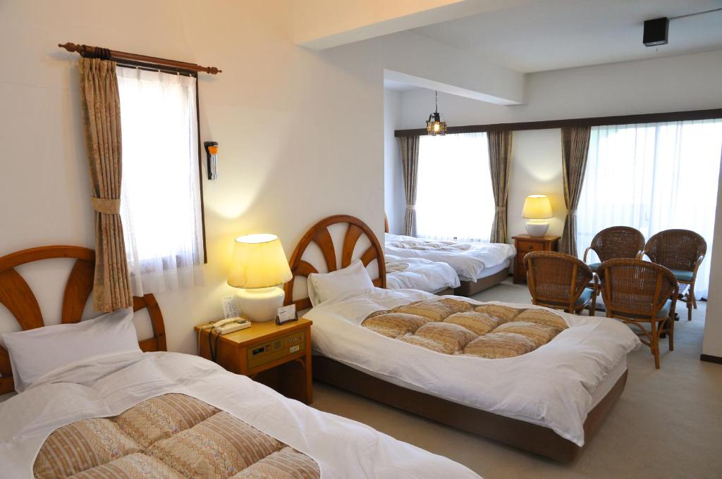 Postel nebo postele na pokoji v ubytování Tateyama Resort Hotel