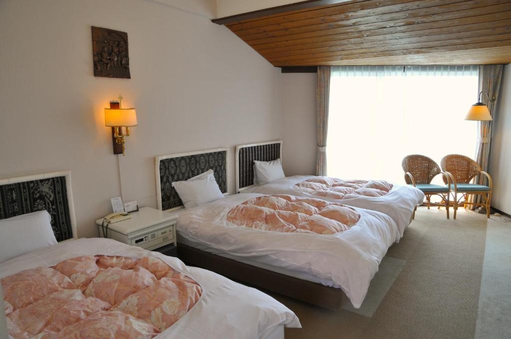 Postel nebo postele na pokoji v ubytování Tateyama Resort Hotel