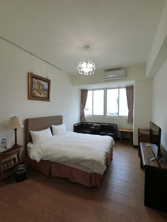 Postel nebo postele na pokoji v ubytování Long Zhi Yue Hotel