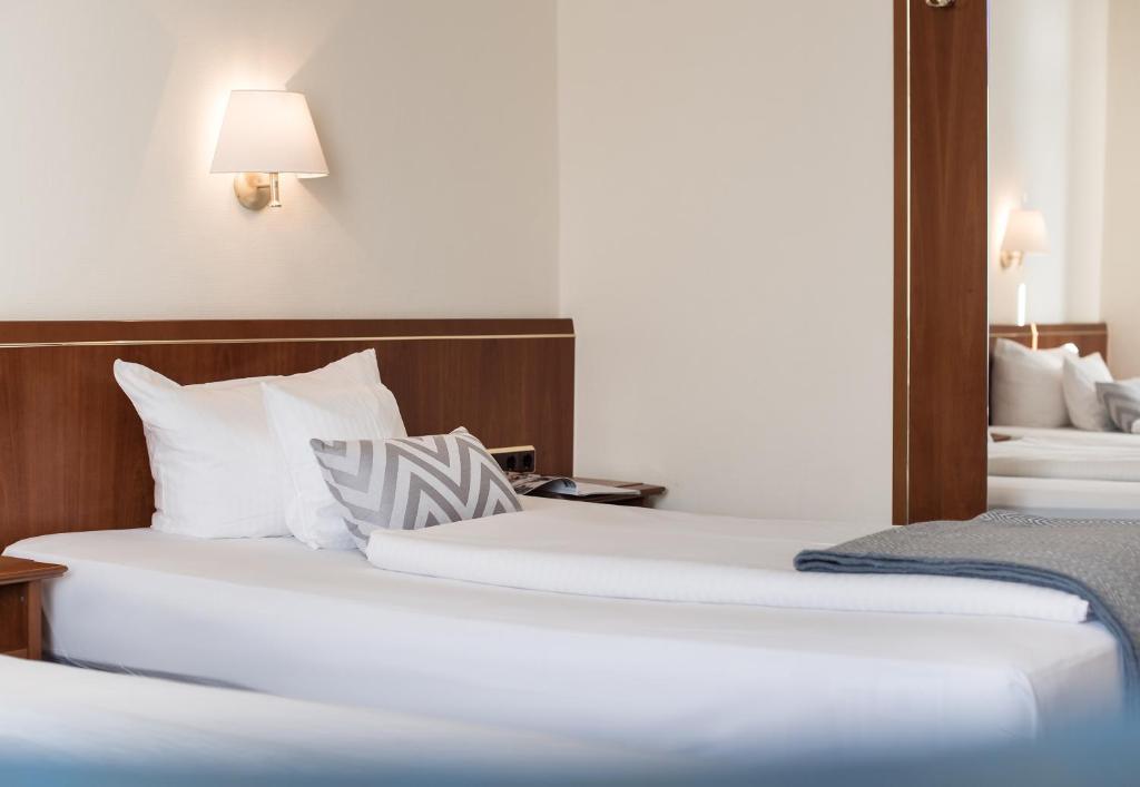 Postel nebo postele na pokoji v ubytování Akzent Hotel Köhler