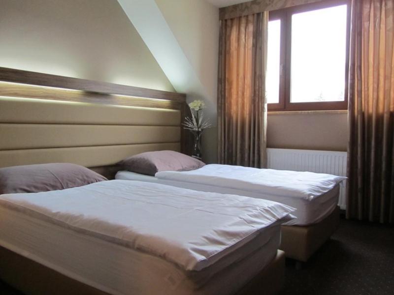 Postel nebo postele na pokoji v ubytování Hotel Opara