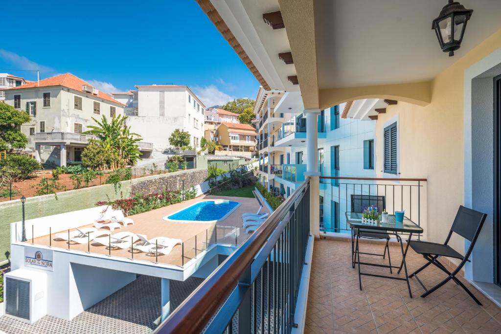 a balcony with a view of a swimming pool at Funchal SilverWood Apartment - by LovelyStay in Funchal