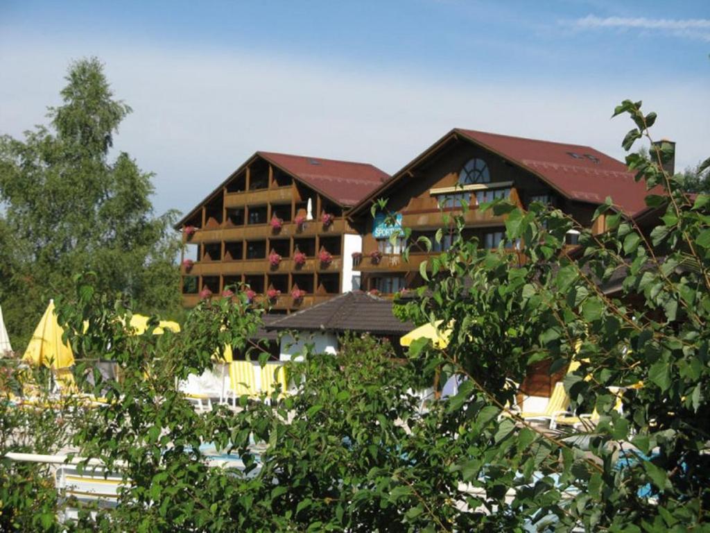 a hotel building with trees in front of it at Appartementhaus im Himmelreich in Lam