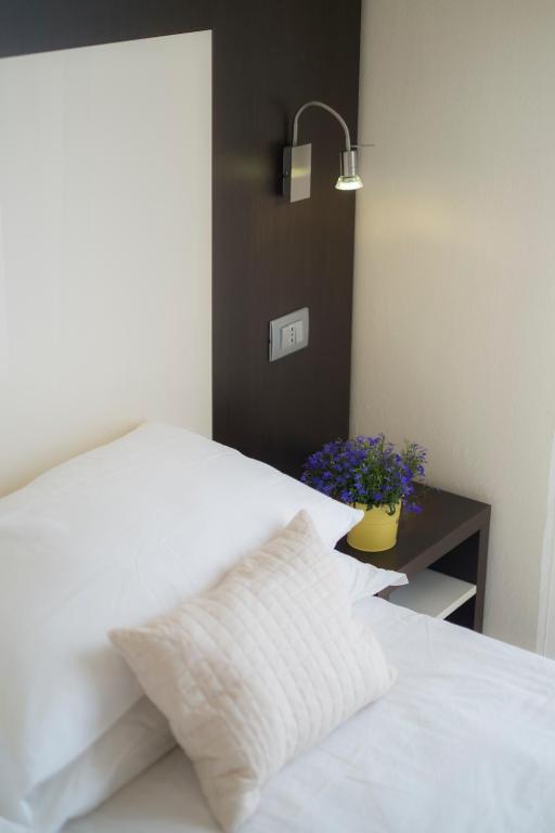 Postel nebo postele na pokoji v ubytování Hotel Ricchi