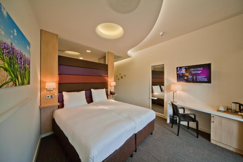 Postel nebo postele na pokoji v ubytování Hotel Udens Duyn