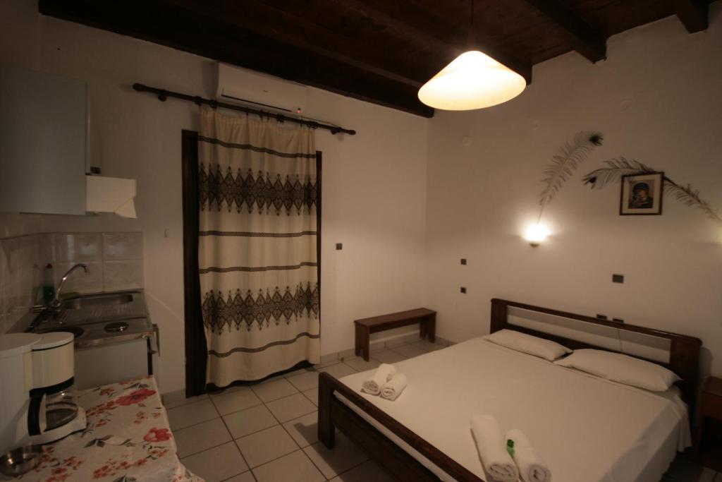 A bed or beds in a room at Chania Rooms