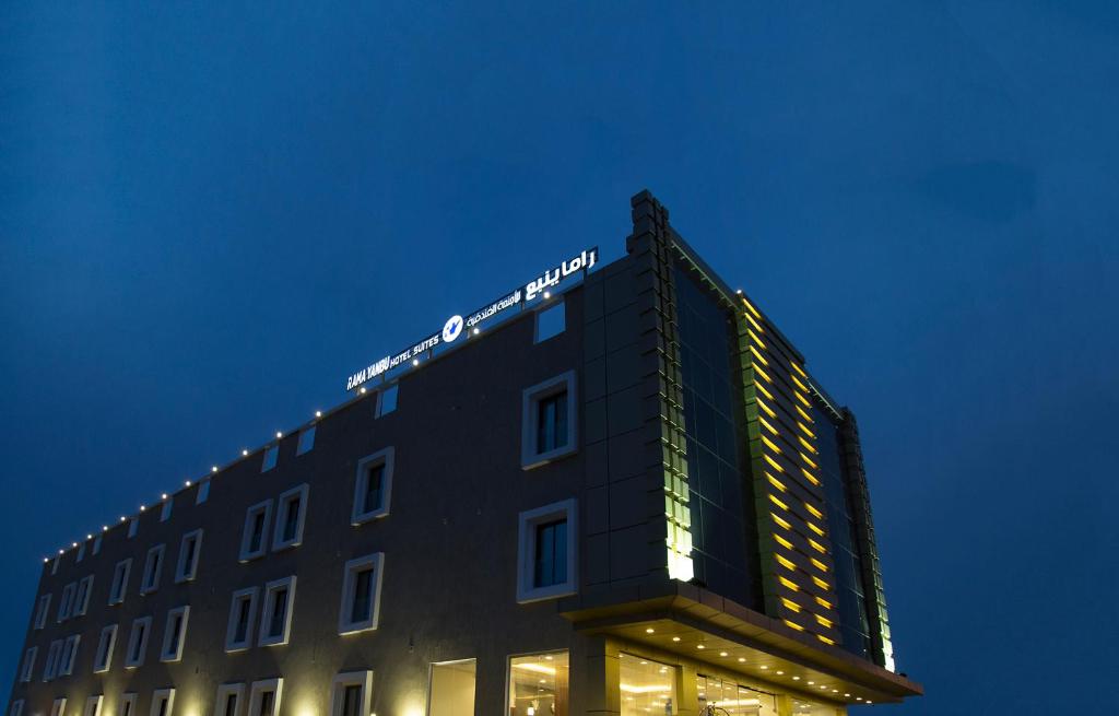 un edificio con un cartel en la parte superior en Rama Yanbu Hotel-Suite, en Yanbu