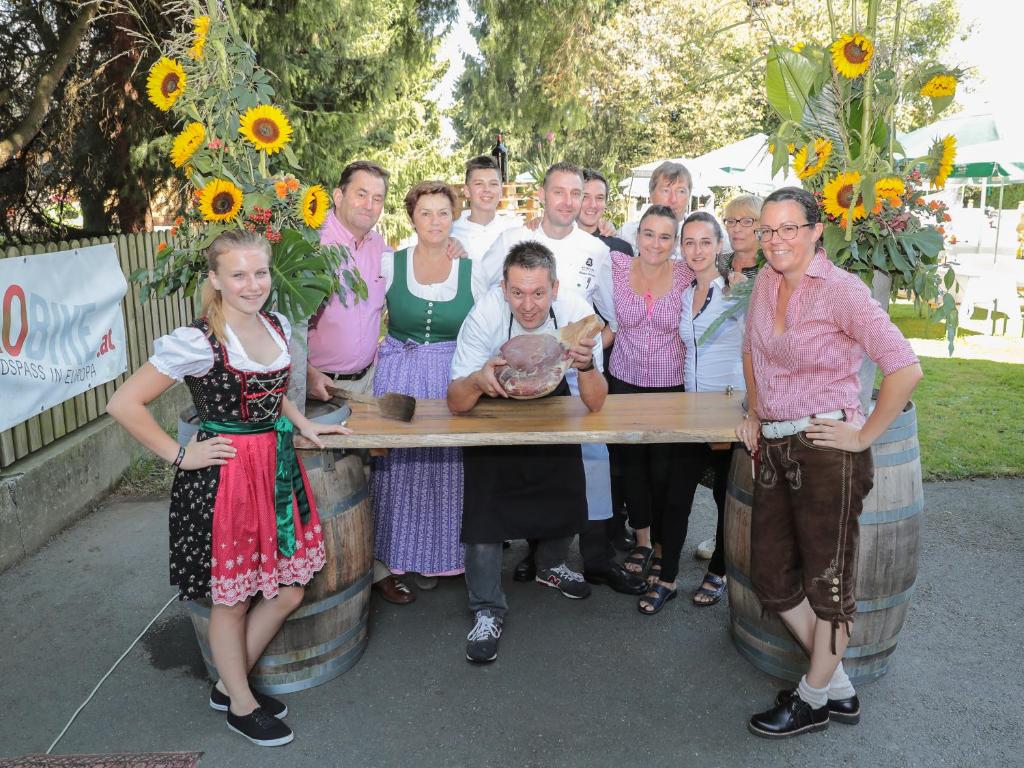 a group of people posing for a picture on a table at Wirtshaus Restaurant Pension Steirerland in Mureck