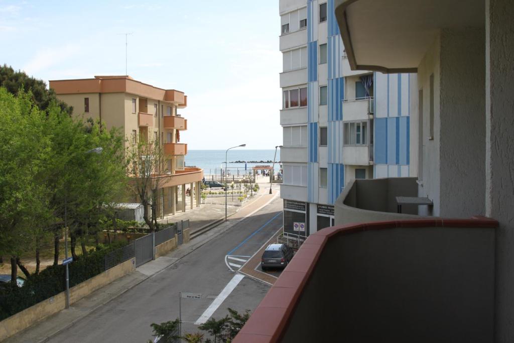 a view of a street from a balcony of a building at Alfa Apartmerts in Lido di Pomposa