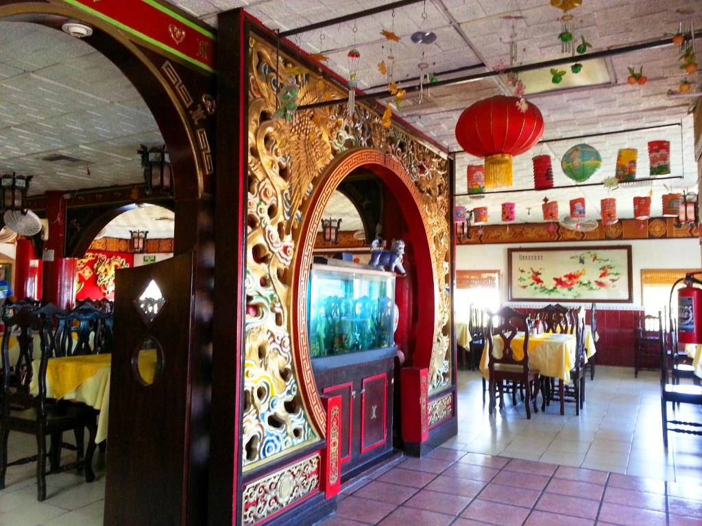 Hotel Pekin في لاباز: مطعم مع صالة طعام مع طاولات وكراسي