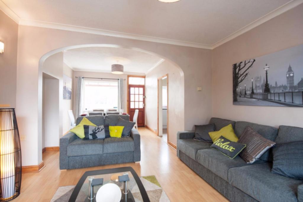 a living room with a couch and a table at Westfield House in Hinckley