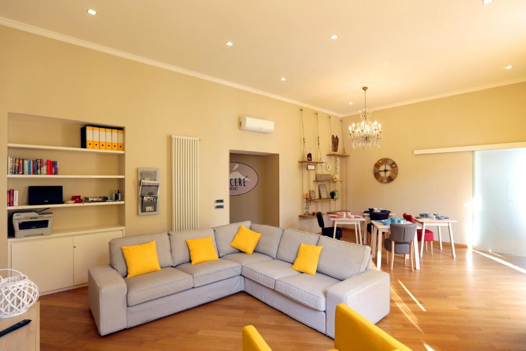 a living room with a gray couch with yellow pillows at I Vicerè B&B Deluxe in Naples