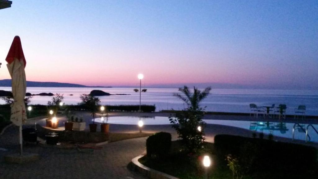 a view of a pool at night with the ocean at Alexander Lozenets Beach Complex Apartment in Lozenets